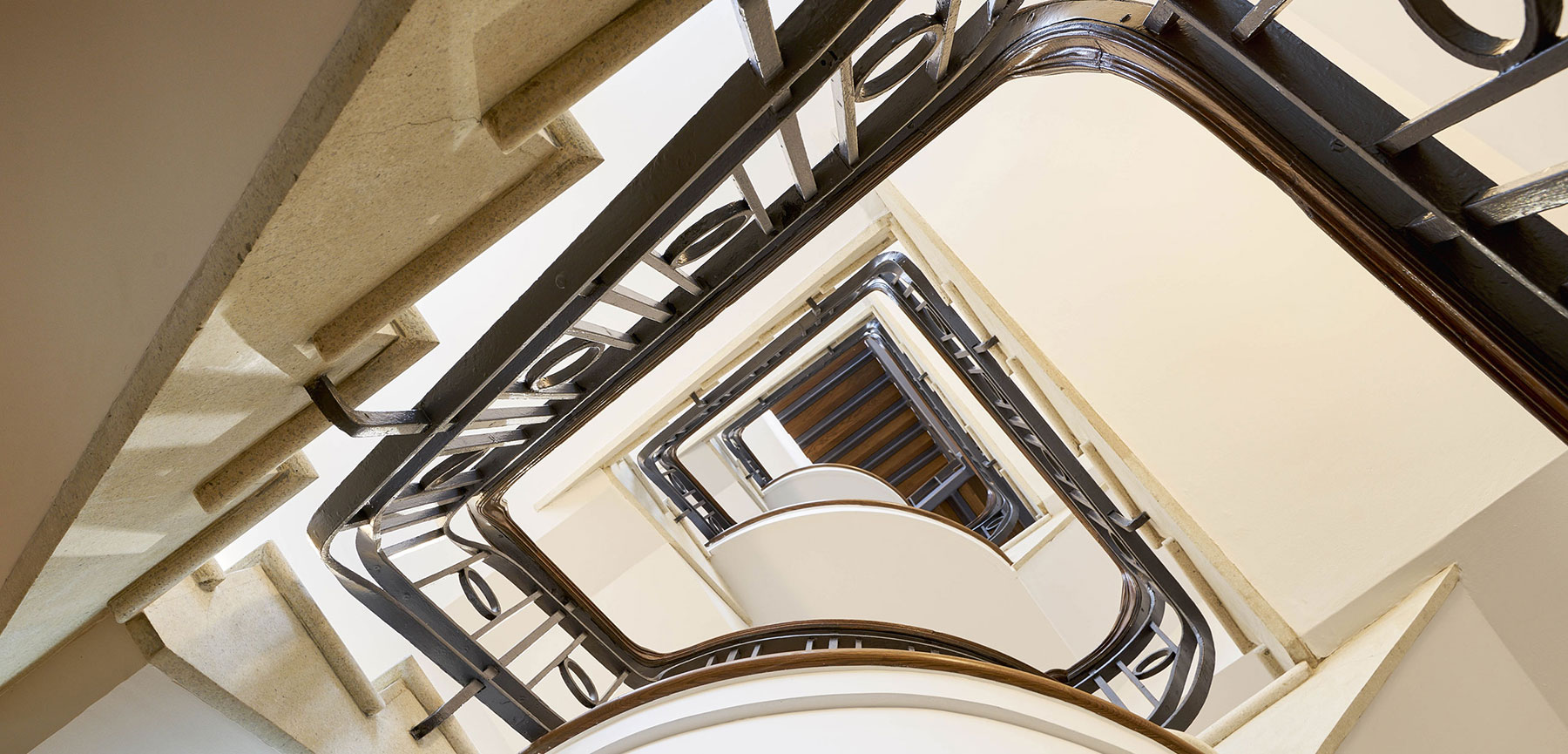 The winding terrazzo staircase runs throughout the building 